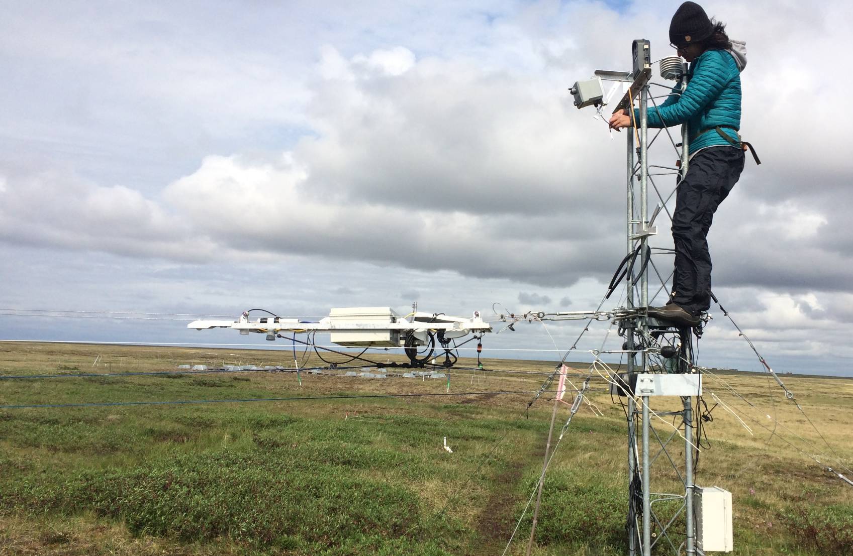 researcher fixing equipment at Atqasuk Alaska